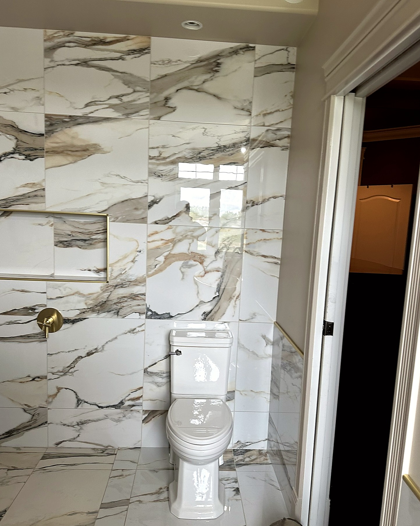 Bathroom with large light tile, a glass shower, and a floating vanity with a vessel sink.